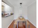Cozy dining space with modern lighting fixtures and adjacent kitchen access at 1181 Church St # G, Decatur, GA 30030