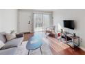 Bright living room with sliding glass doors, hardwood floors, and a comfortable seating area at 1181 Church St # G, Decatur, GA 30030