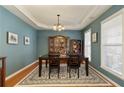 Dining room with hardwood floors, trey ceiling, decorative rug, and large picture windows at 301 Ridgewood Trl, Canton, GA 30115