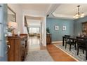 Open entryway into the dining and living rooms featuring hardwood floors and neutral colors at 301 Ridgewood Trl, Canton, GA 30115