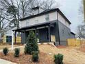 Side view of a newly constructed home with a 'For Sale' sign and a freshly landscaped yard at 3085 Jackson St, Hapeville, GA 30354
