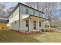 Charming two-story home with a inviting front porch and a well-manicured lawn at 3163 Old Jonesboro Rd, Hapeville, GA 30354