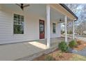 Side view of a charming front porch with a concrete floor and views of the front yard at 3163 Old Jonesboro Rd, Hapeville, GA 30354