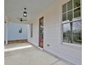 Spacious front porch with a red door, ceiling fans, and ample natural light at 3163 Old Jonesboro Rd, Hapeville, GA 30354