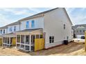 Townhouse exterior featuring a screened porch and newly installed backyard sod at 1327 Fern Ridge Ct # 27, Norcross, GA 30093