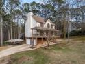 View of the home with attached two-car garage and a spacious carport on the driveway at 270 Fawn Dr, Canton, GA 30115