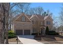 Charming two-story brick home featuring a two-car garage and manicured landscaping at 7290 Weber St, Atlanta, GA 30349