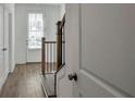 Bright entryway with hardwood floors, stairway and natural light at 1115 Larkin Dr, Buford, GA 30518