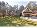 Beautiful gray home with a manicured lawn and attached two-car garage at 304 Old Yorkville Rd, Dallas, GA 30157