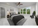 Bright main bedroom features large windows, neutral decor, and a modern black color scheme at 1255 Windmill Pkwy, Cumming, GA 30041