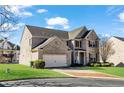 Brick two-story home featuring attached two-car garage and well-maintained lawn at 2468 Cannon Farm Ln, Duluth, GA 30097
