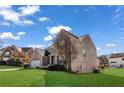 Exterior shot of two-story brick home with manicured lawn and blue sky at 2468 Cannon Farm Ln, Duluth, GA 30097
