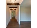 Spacious hallway features hardwood floors, white walls and trim, and modern lighting at 5360 Memento Trce, Cumming, GA 30040