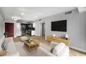 Bright living room with modern furnishings, wood floors, and open kitchen at 199 14Th Ne St # 2407, Atlanta, GA 30309
