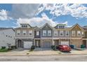 Attractive townhome complex showcasing varied exterior colors and two-car garages at 5036 Longview Walk, Decatur, GA 30035