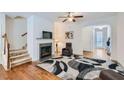 Inviting living room with a fireplace, hardwood floors, and staircase to the upper level at 5036 Longview Walk, Decatur, GA 30035