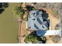 Areal view of a house showing a large roof, expansive grounds, waterfront access, and private driveway at 2143 Bogans Lake Path, Dunwoody, GA 30338