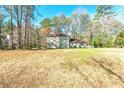 Well-maintained two-story home on a large lot surrounded by mature trees and a spacious front yard at 220 Mimosa Dr, Fayetteville, GA 30214