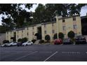 The exterior of this two-story tan condominium building features visitor parking at 2398 Lawrenceville Hwy # K, Decatur, GA 30033