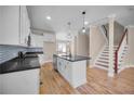 Modern kitchen with an island, stainless steel appliances, and hardwood floors at 4861 Pinnacle Dr, Stone Mountain, GA 30088