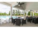 Inviting outdoor lounge area with comfortable seating, ceiling fans, and views of the pool at 108 Fieldbrook Xing, Holly Springs, GA 30115