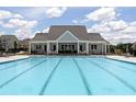 Large community pool featuring ample seating and a covered lounge area, perfect for relaxation at 108 Fieldbrook Xing, Holly Springs, GA 30115