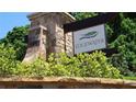 Edgewater community sign nestled among lush landscaping and stonework near the community entrance at 108 Fieldbrook Xing, Holly Springs, GA 30115