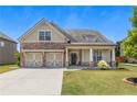 Exterior elevation view of charming home showcasing a stone and siding facade and a two-car garage at 145 Meadow Branch Ln, Dallas, GA 30157