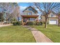 Charming two-story home featuring a welcoming front porch and manicured lawn at 1880 Eastfield St, Decatur, GA 30032