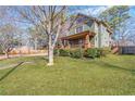Beautiful two-story home with a manicured lawn and inviting front porch provides classic curb appeal at 1880 Eastfield St, Decatur, GA 30032