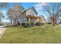 A well-maintained lawn complements the charming two-story home with a cozy covered front porch at 1880 Eastfield St, Decatur, GA 30032