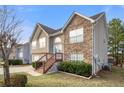 Two-story home features stone accents, an attached two-car garage, and a charming front entrance at 521 Carlsbad Cv, Stockbridge, GA 30281
