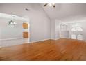 Spacious open-concept living area with hardwood floors, high ceilings, and plenty of natural light at 521 Carlsbad Cv, Stockbridge, GA 30281