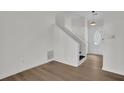 Bright entryway with hardwood floors, leading to a staircase and featuring a modern front door at 4391 Shiloh Hills Dr, Snellville, GA 30039