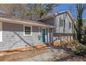 Two-story home featuring a light blue front door, gray siding, and a landscaped yard at 4391 Shiloh Hills Dr, Snellville, GA 30039