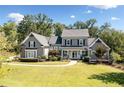 Charming gray home featuring a well-manicured front lawn and inviting entryway at 276 Red Gate Dr, Canton, GA 30115