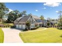Impressive gray home with a three-car garage, well-kept lawn, and elegant curb appeal at 276 Red Gate Dr, Canton, GA 30115