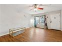 Bright living room with a ceiling fan, modern decor, and hardwood floors at 1042 Wedgewood Ct, Conyers, GA 30012