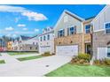 New townhomes line the street, each boasting unique brick and siding exteriors, and inviting curb appeal at 5769 Tillman Way, Powder Springs, GA 30127