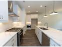 Bright, open kitchen featuring white cabinets, quartz countertops, and stainless appliances at 1434 Casteel Lake Ln # 273, Buford, GA 30518