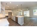 Modern kitchen with stainless steel appliances, large island, and hardwood flooring at 1434 Casteel Lake Ln # 273, Buford, GA 30518