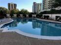 Relaxing pool surrounded by mature trees and lounge chairs, perfect for community enjoyment at 195 14Th Ne St # 312, Atlanta, GA 30309
