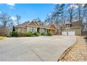 Sprawling home boasts attached garages and a long circular driveway, surrounded by mature trees at 30 Crolley Ln, White, GA 30184