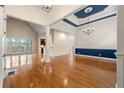 Expansive living room featuring hardwood floors, tall ceilings, columns, and a walkout balcony at 30 Crolley Ln, White, GA 30184