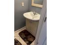 Bathroom featuring a single sink vanity with a modern faucet, set against neutral tile and gray walls at 1470 Andrews Nw St, Atlanta, GA 30314