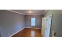 A naturally lit living room with hardwood floors, grey walls, and a window facing the backyard at 1470 Andrews Nw St, Atlanta, GA 30314