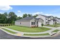 Attractive one-story home with a manicured lawn in a suburban setting, featuring a two-car garage at 8590 Secretariat Dr, Lithonia, GA 30058