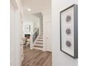 Hallway view with modern artwork, showcasing the home's elegant design and staircase at 1597 Aiden Way # 47, Conyers, GA 30013