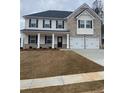 Two-story home features a brick and siding facade, dark shutters, a two-car garage and manicured lawn at 738 Great Oak Pl, Villa Rica, GA 30180