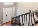Bright foyer featuring a white front door with sidelights, staircase, and hardwood flooring at 1004 Hamilton Dr, Locust Grove, GA 30248